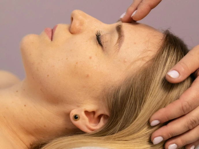 a woman getting a facial massage at a spa